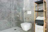 Bathroom with glass shower and storage shelf — NOVA interior reference photograph