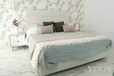 Bedroom with green bedding — NOVA interior reference photograph