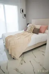 Bedroom with pink and beige cushions — NOVA interior reference photograph
