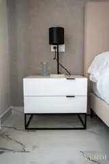 Bedside cabinet with black lamp — NOVA interior reference photograph