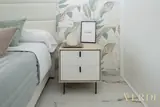 Bedside cabinet and leaf-pattern wallpaper — NOVA interior reference photograph