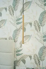 Bedside pendant and leaf-pattern wallpaper — NOVA interior reference photograph