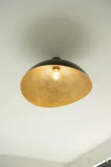 Ceiling pendant with gold-coloured shade — NOVA interior reference photograph