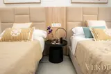 Twin beds with central bedside table — NOVA interior reference photograph