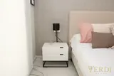 White bedside cabinet and lamp — NOVA interior reference photograph